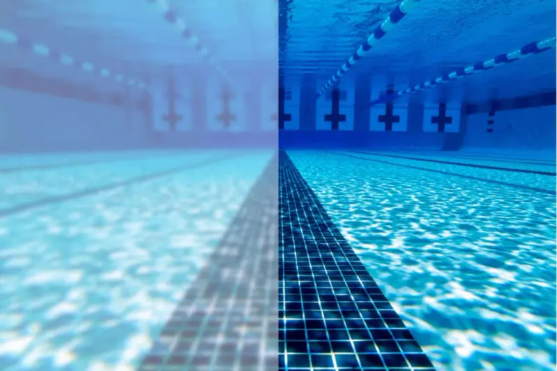 Underwater view of a swimming pool, half clear and half cloudy, with lane lines and lane markers.